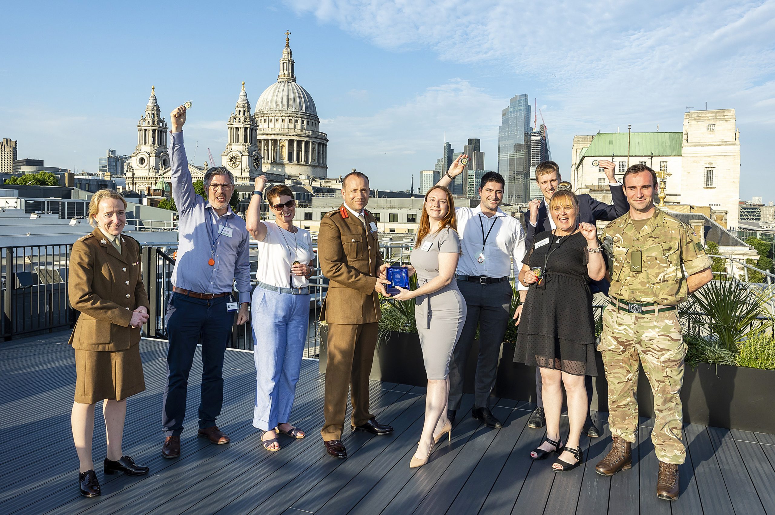 The winners of the 3MI Intelligence challenge celebrating their success on a rooftop in front of the St. Pauls Cathedral