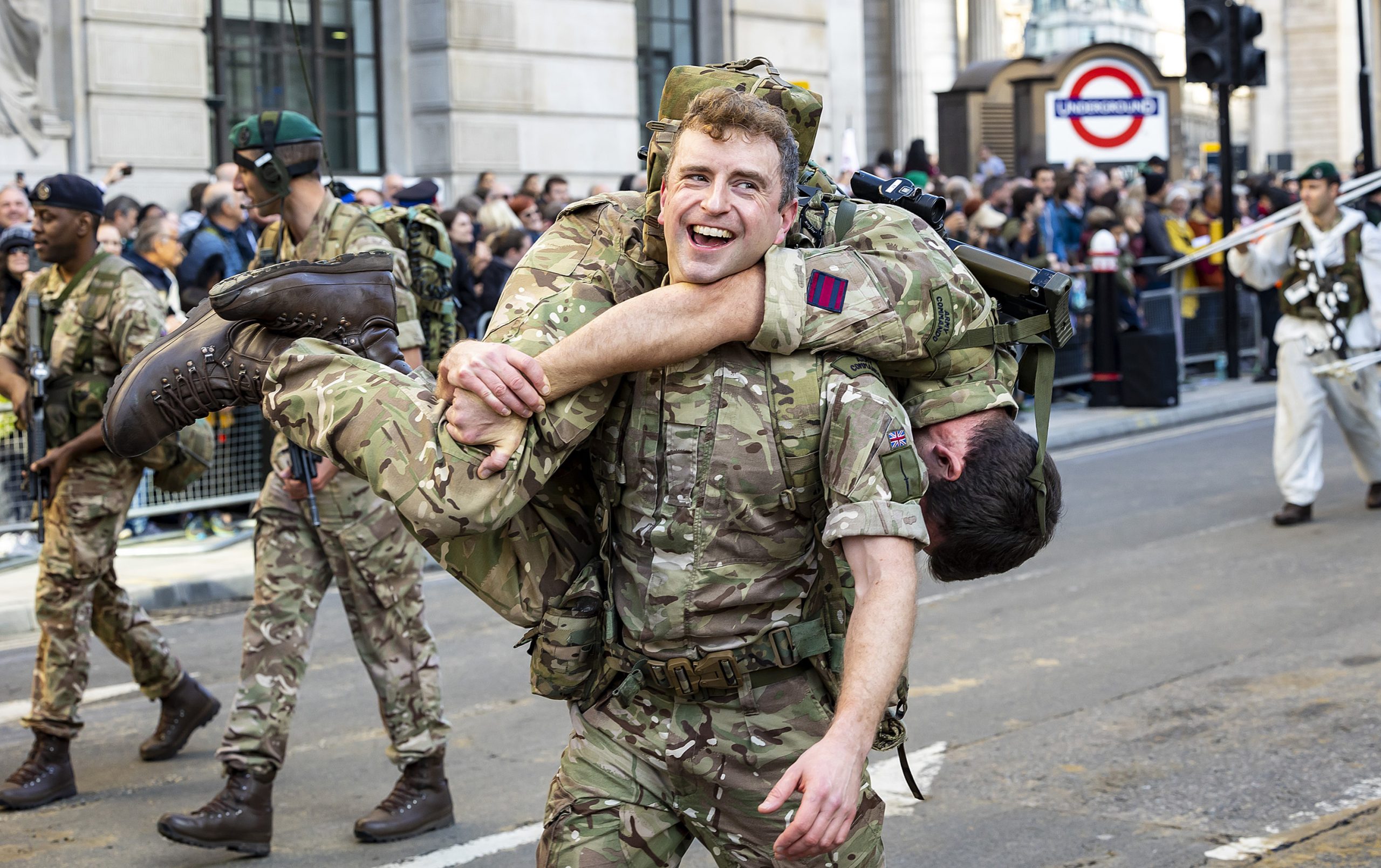 A soldier carrying his teammate on his shoulder during the Lord Mayor's Show 2022