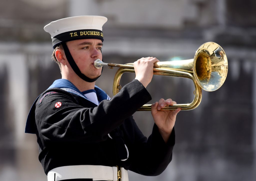 A sea cadet playing the bugle during the Lord Mayor's Cadet Music Competition