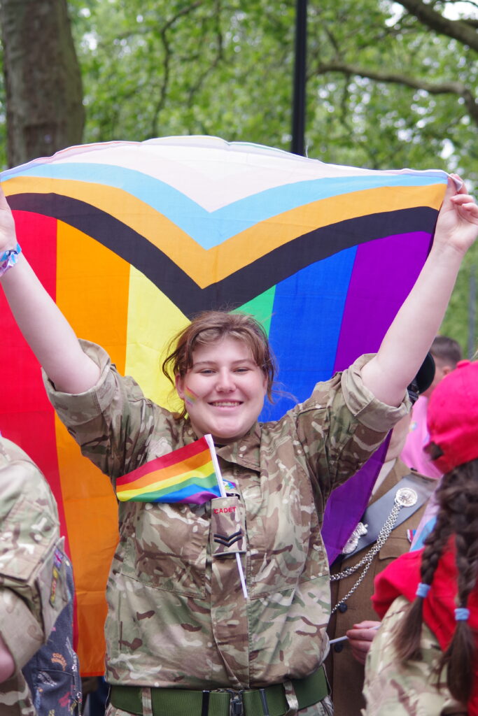 A cadet holding the pride flag during the London Pride Parade 2023