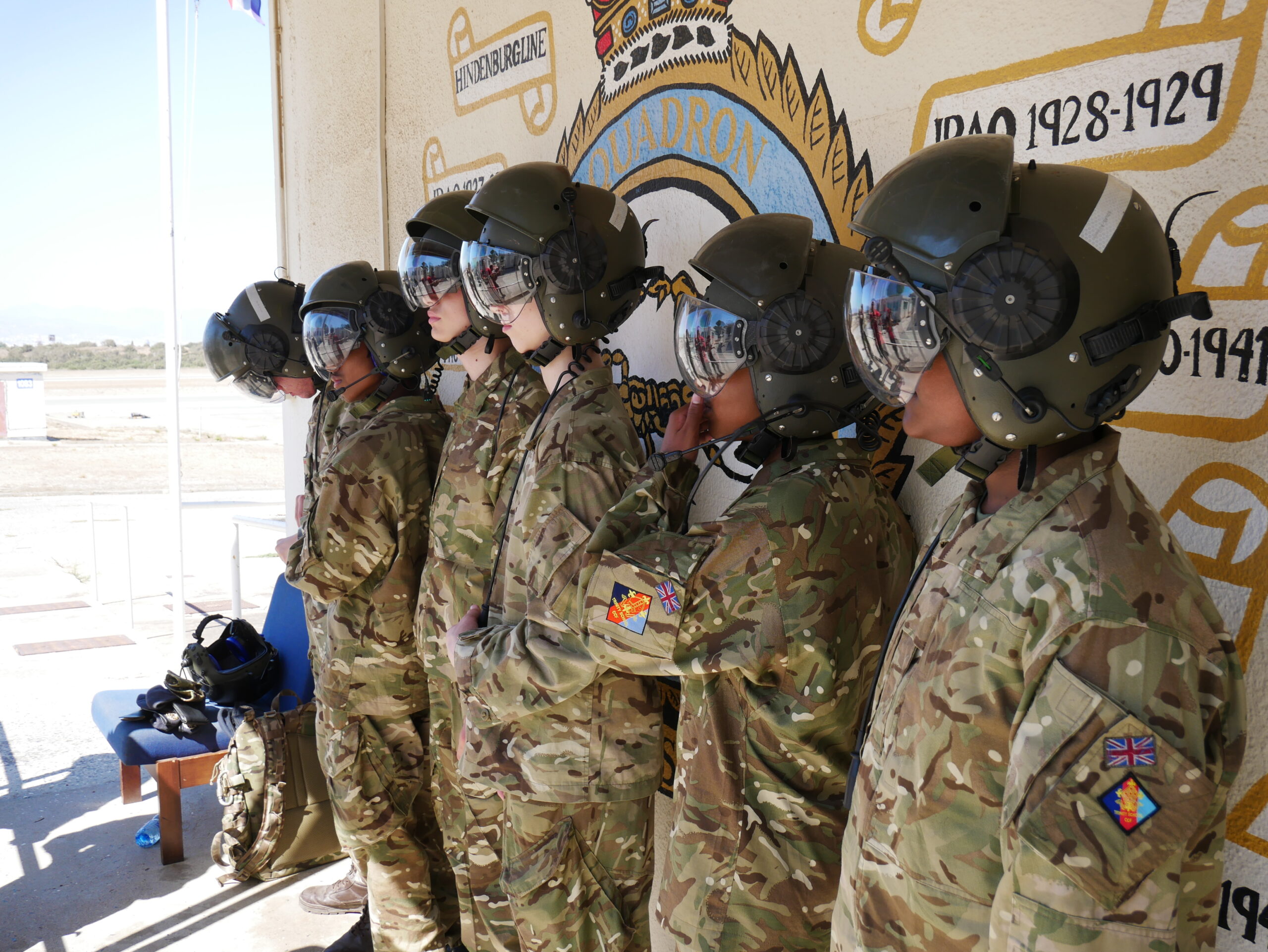 Cadets standing in a line waiting to get on a helicopter