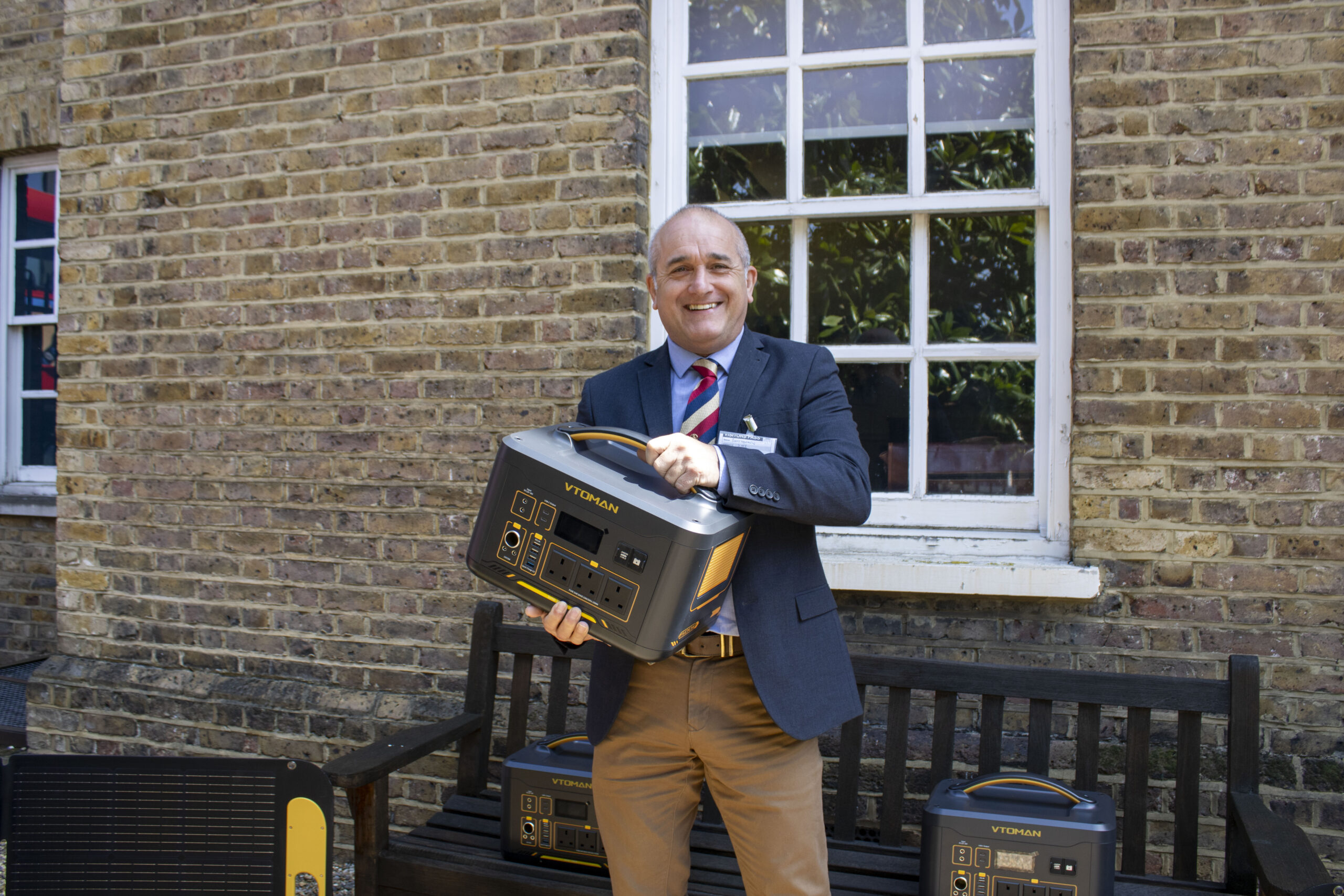 Gary receiving a battery charger with solar panels