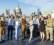 The winners of the 3MI Intelligence challenge celebrating their success on a rooftop in front of the St. Pauls Cathedral