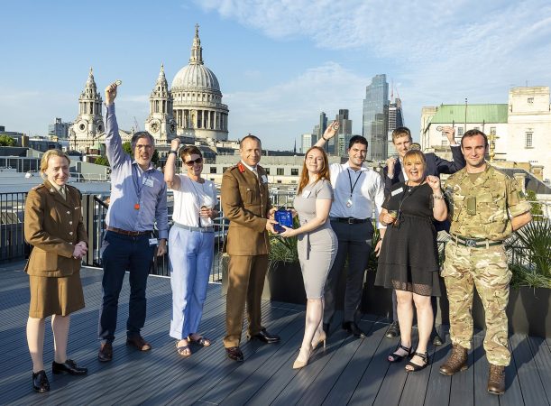 The winners of the 3MI Intelligence challenge celebrating their success on a rooftop in front of the St. Pauls Cathedral