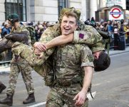 A soldier carrying his teammate on his shoulder during the Lord Mayor's Show 2022