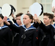 Sea Cadets holding their hats as a sign of respect for the king