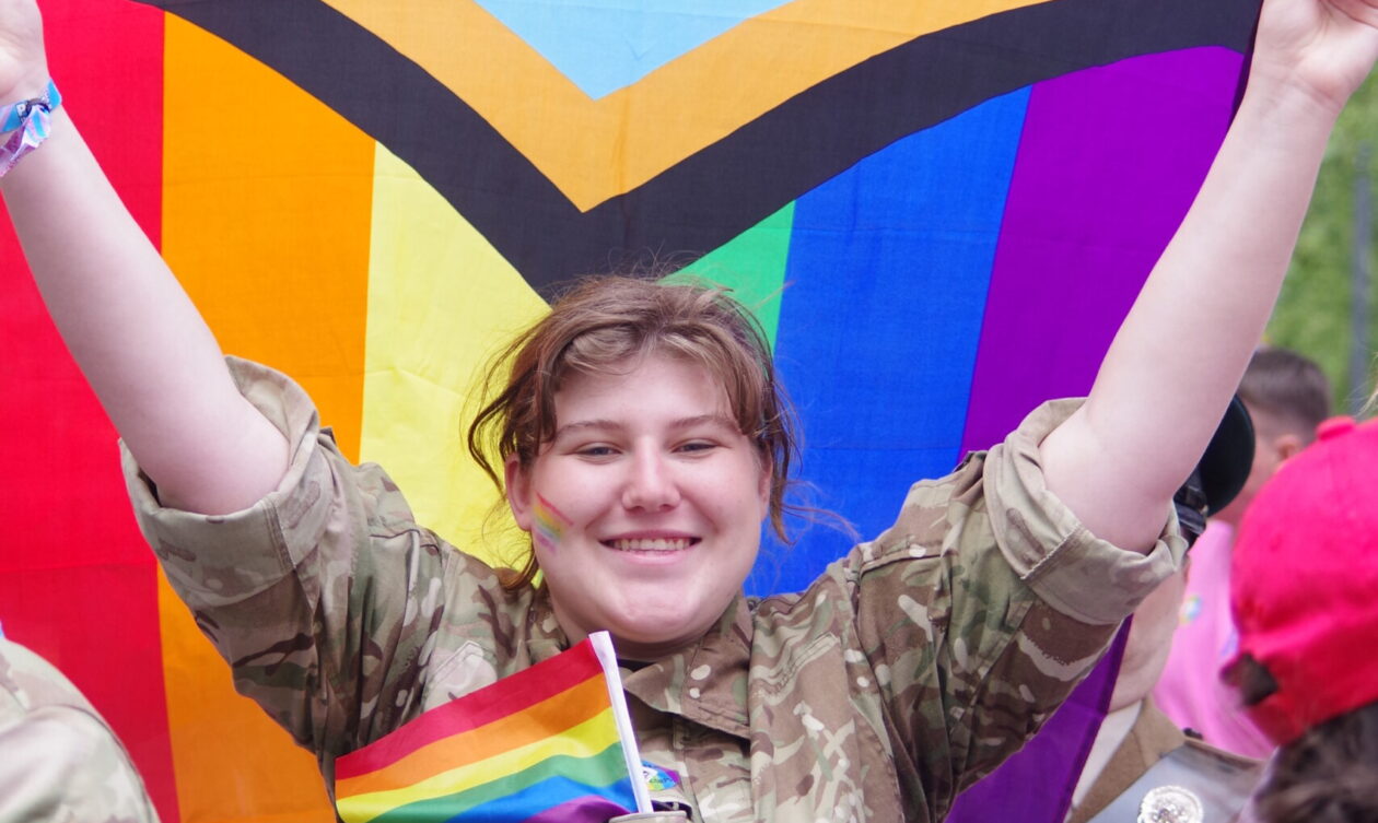 A cadet holding the pride flag during the London Pride Parade 2023